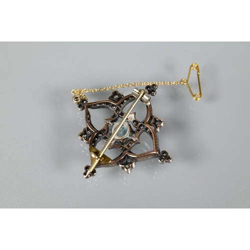 234 - A Victorian brooch, the central round zircon surrounded by an old cut diamond set shaped Gothic styl... 