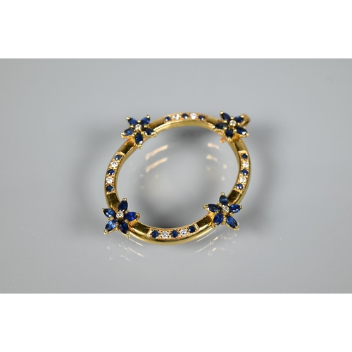 237 - An oval pendant, with mount fittings, set with four sapphire and diamond clusters and with sapphire ... 