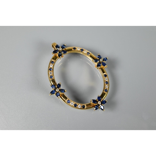 237 - An oval pendant, with mount fittings, set with four sapphire and diamond clusters and with sapphire ... 