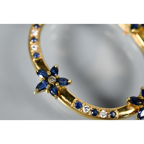 237 - An oval pendant, with mount fittings, set with four sapphire and diamond clusters and with sapphire ... 