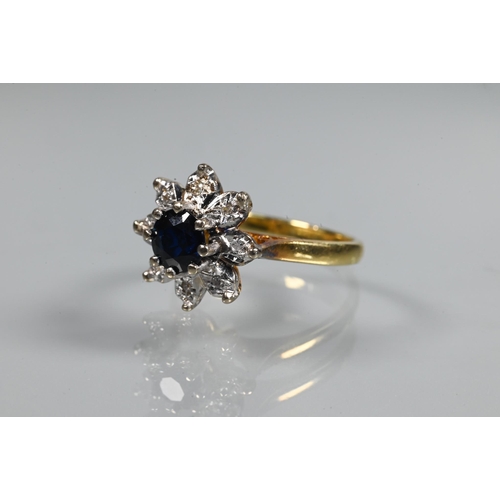 240 - A diamond and sapphire cluster ring, the central circular claw set blue sapphire with eight small di... 