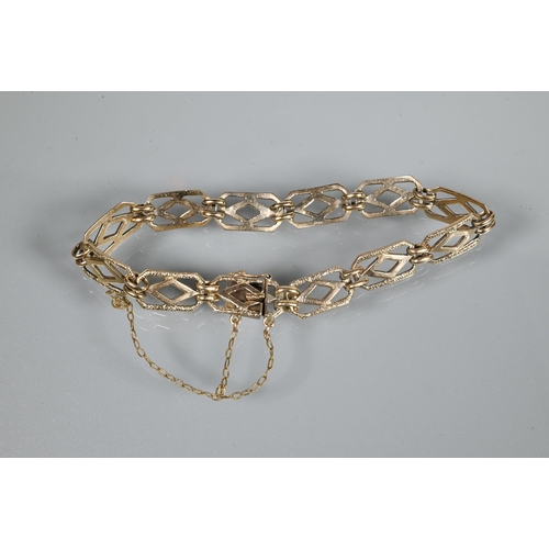 247 - A yellow metal bracelet formed of rectangular open links with safety chain attached (broken) and con... 