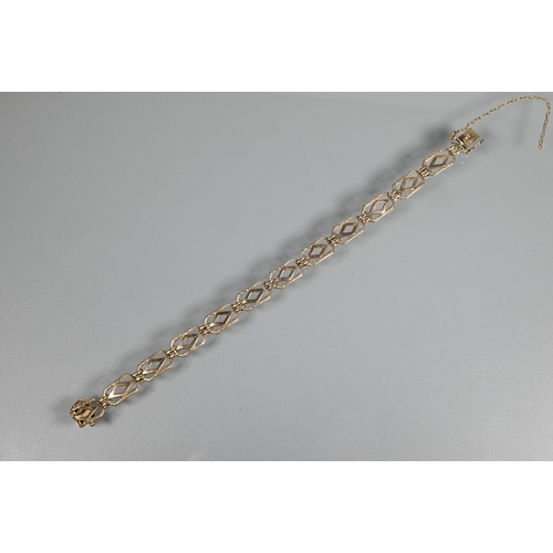 247 - A yellow metal bracelet formed of rectangular open links with safety chain attached (broken) and con... 