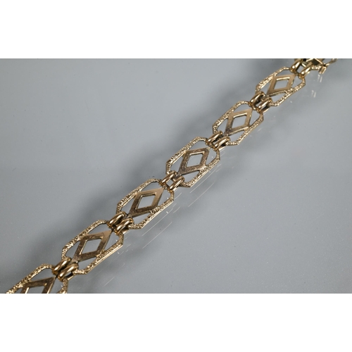 247 - A yellow metal bracelet formed of rectangular open links with safety chain attached (broken) and con... 