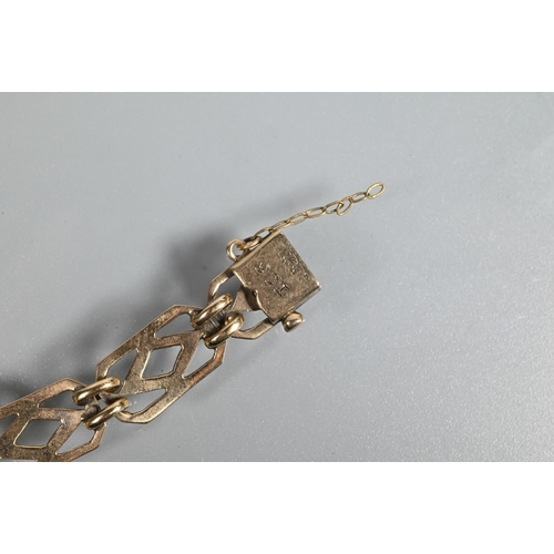 247 - A yellow metal bracelet formed of rectangular open links with safety chain attached (broken) and con... 