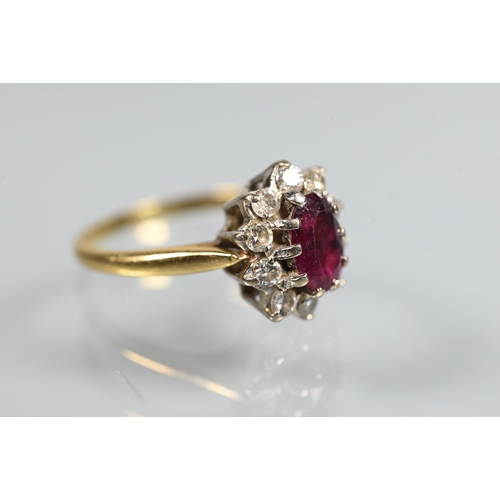 249 - A ruby and diamond cluster ring, the oval ruby with ten claw set diamonds around, 18ct yellow gold s... 