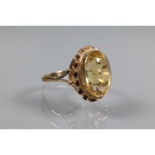 254 - An oval citrine ring set 9ct yellow gold with rope and scallop edge setting, size R 1/2