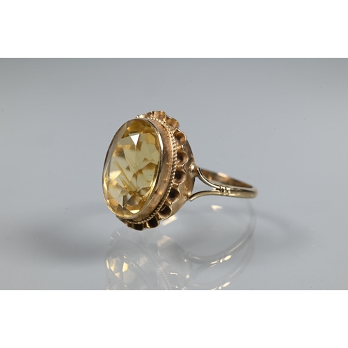 254 - An oval citrine ring set 9ct yellow gold with rope and scallop edge setting, size R 1/2