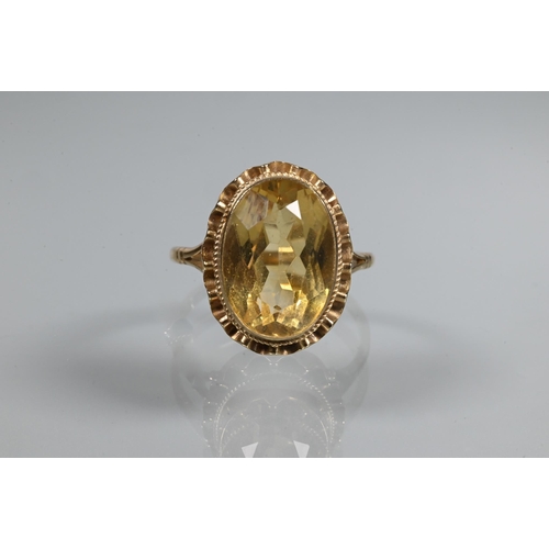 254 - An oval citrine ring set 9ct yellow gold with rope and scallop edge setting, size R 1/2