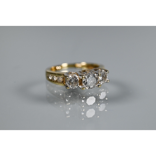 266 - A three-stone diamond ring, the three round claw set brilliant cut diamonds in raised setting above ... 