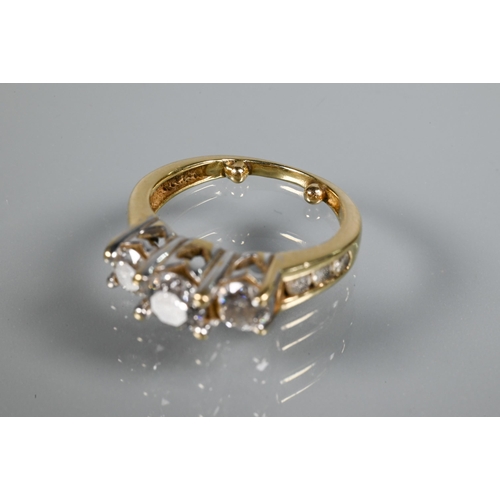 266 - A three-stone diamond ring, the three round claw set brilliant cut diamonds in raised setting above ... 