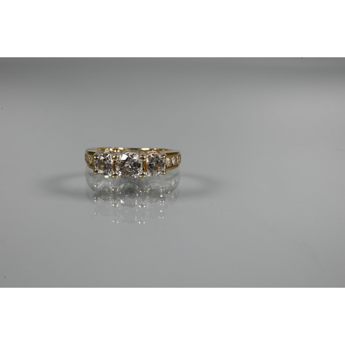 266 - A three-stone diamond ring, the three round claw set brilliant cut diamonds in raised setting above ... 