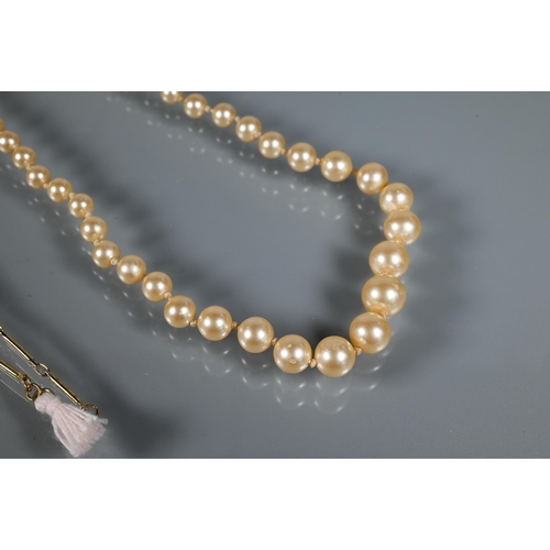 268 - A graduated imitation pearl neckace knotted throughout onto yellow metal clasp stamped Japan to/w th... 