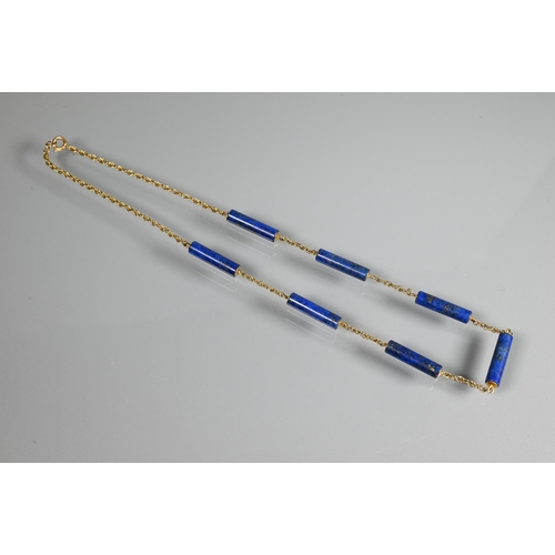 270 - A necklace formed of seven cylindrical lapis lazuli beads on yellow metal double link chain, stamped... 