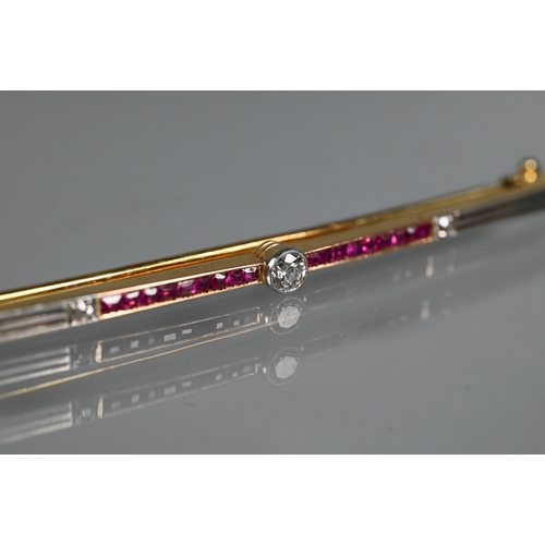 284 - An Art Deco ruby and diamond bar brooch, the calibre set rubies flanking a central millgrain set dia... 