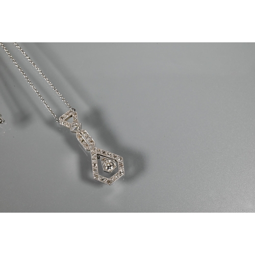 287 - An Art Deco diamond set pendant on chain of open stylised geometric form, with round brilliant cut m... 