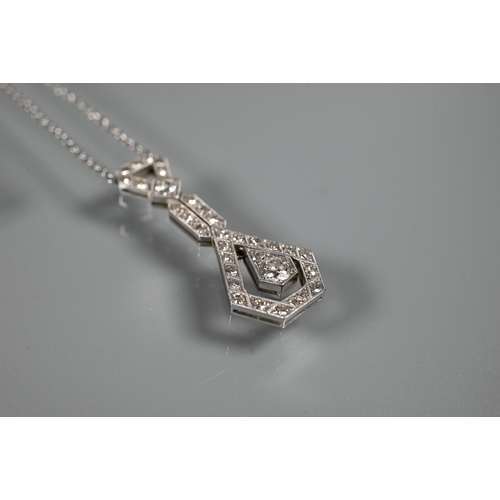 287 - An Art Deco diamond set pendant on chain of open stylised geometric form, with round brilliant cut m... 