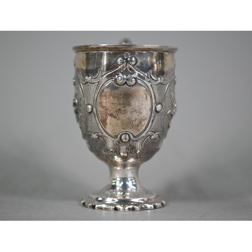 29 - WITHDRAWN A Victorian silver Christening cup with embossed floral decoration, scroll handle and stem... 