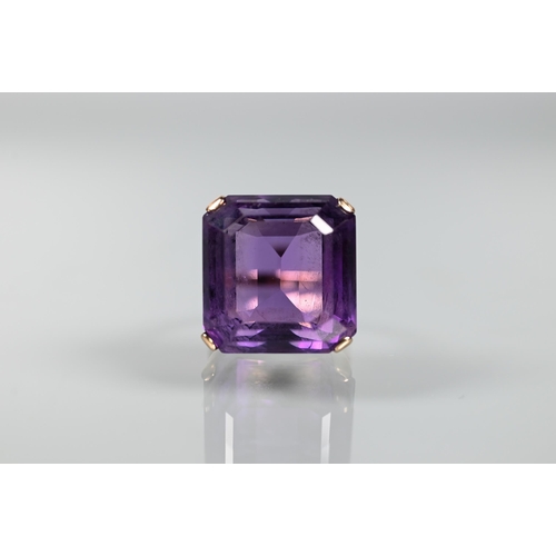 313 - A square amethyst cocktail ring, claw set yellow metal with decorative mount, size O, size 1.8 x 1.8... 