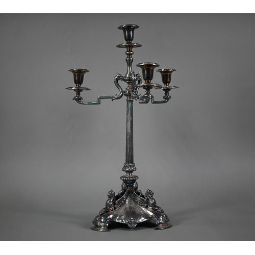 33 - A large Victorian electroplated three-branch candelabrum with four sconces raised on a reeded pillar... 