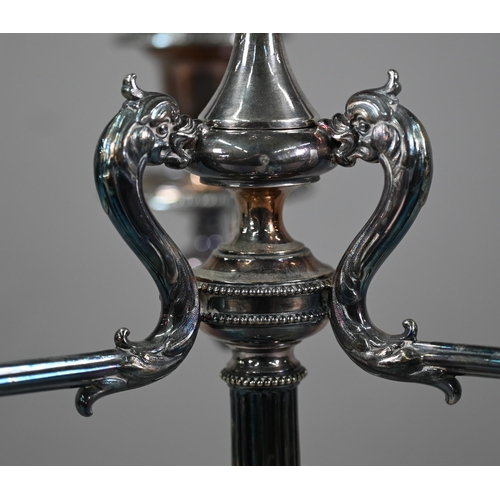 33 - A large Victorian electroplated three-branch candelabrum with four sconces raised on a reeded pillar... 