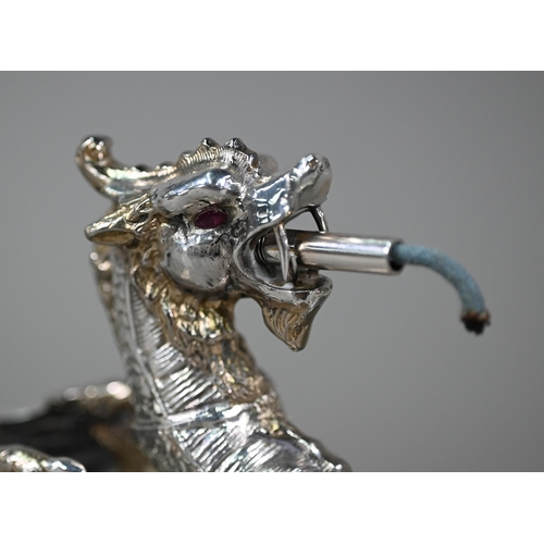 50 - An antique electroplated table cigar lighter cast as a dragon with unscrewing head, on Indian blackb... 