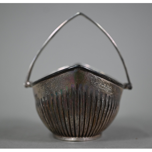 54 - An Edwardian silver sugar basin of half-reeded elliptical form with swing handle, Barker Brother, Bi... 