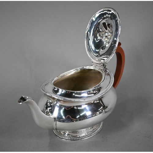 58 - A heavy quality silver three-piece tea service of oval pot-bellied form with moulded rims and raised... 
