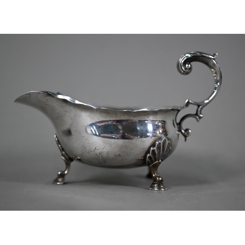 62 - A silver sauce-boat in the Georgian manner with scroll handle and hoof feet, Mappin & Webb, Shef... 