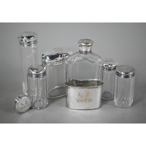 63 - Three cut glass silver-topped toilet jars and a spare lid, London 1892, engraved with initials and c... 