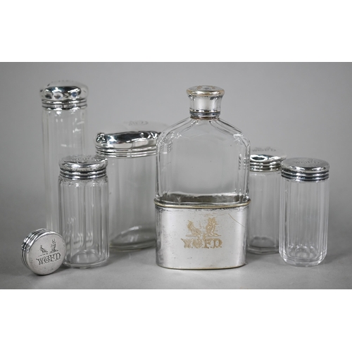 63 - Three cut glass silver-topped toilet jars and a spare lid, London 1892, engraved with initials and c... 