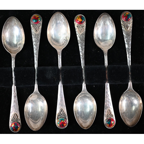 68 - Langstone Silverworks (Bernard Instone): a set of six planished silver teaspoons with enamel boss fi... 