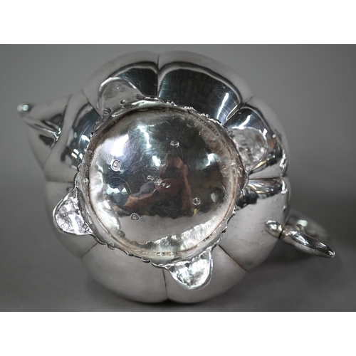 70 - A Victorian silver melon-shaped teapot with cast melon finial and scroll handle with ivory insulator... 