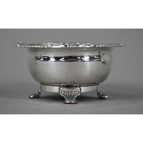 76 - A Regency Irish silver open salt, the egg and dart moulded rim with chased foliate and shell decorat... 