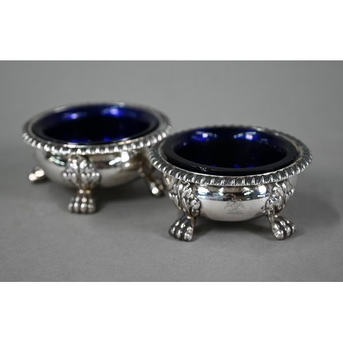 77 - A pair of William IV silver circular open salts in the Regency manner, with blue glass liners and  g... 