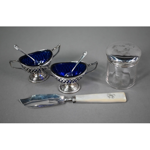 87 - A pair of late Victorian pierced silver open salts with blue glass liners, of oval form with twin ha... 