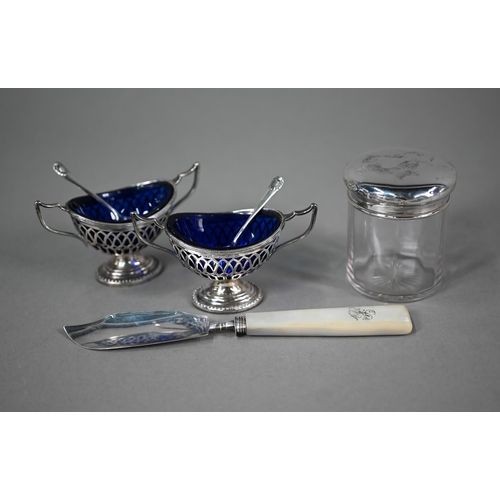 87 - A pair of late Victorian pierced silver open salts with blue glass liners, of oval form with twin ha... 