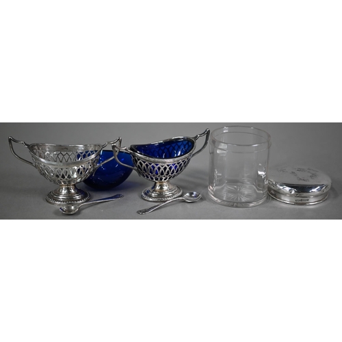 87 - A pair of late Victorian pierced silver open salts with blue glass liners, of oval form with twin ha... 