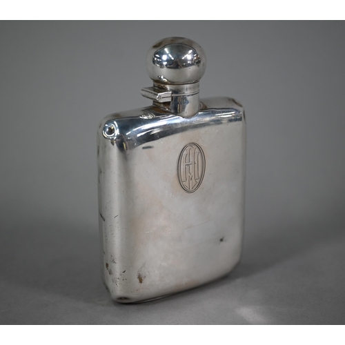 88 - A silver hip flask, the hinged bun cover with bayonet closure, Goldsmiths & Silversmiths Co. Ltd... 