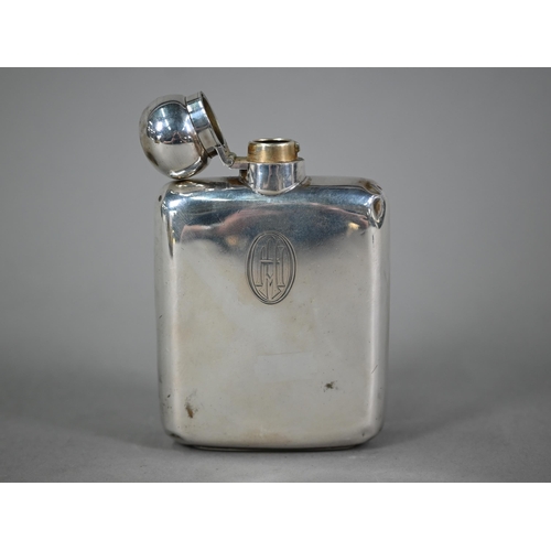 88 - A silver hip flask, the hinged bun cover with bayonet closure, Goldsmiths & Silversmiths Co. Ltd... 