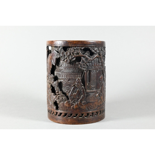 454 - A Chinese double-walled cylindrical bronze brush pot, bitong, cast in relief with pagodas and figure... 