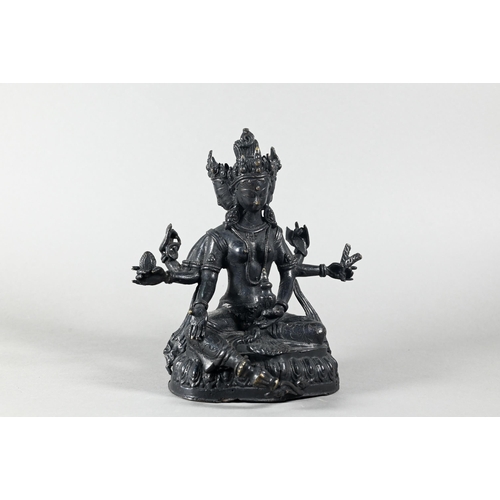 455 - A Nepalese bronze figure of the three-faced Buddhist goddess Vasudhara, seated in royal ease positio... 