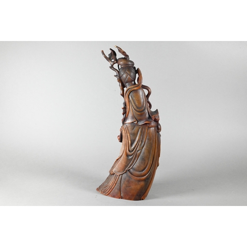 466 - A Chinese carved bovine horn figure of Guanyin (Bodhisattva of compassion) standing in flowing robes... 