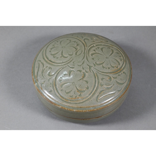 474 - A Chinese celadon circular porcelain box and cover evenly covered with an olive green glaze, the top... 