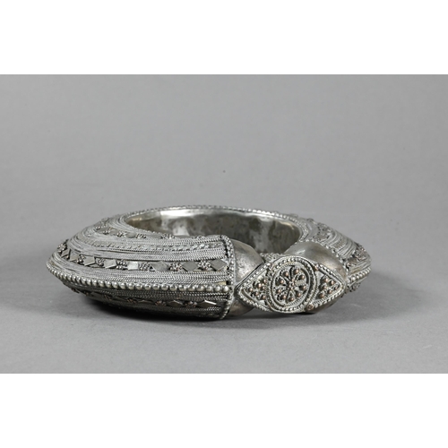489 - A middle-eastern (probably Yemen) antique low grade silver bangle to/w an antiqued circular metal go... 
