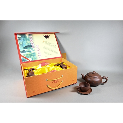 511 - A boxed Chinese Yixing pottery tea set comprising a compressed globular teapot and cover with incise... 