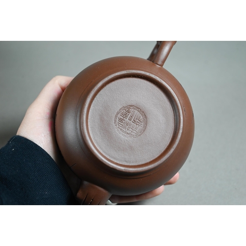 511 - A boxed Chinese Yixing pottery tea set comprising a compressed globular teapot and cover with incise... 