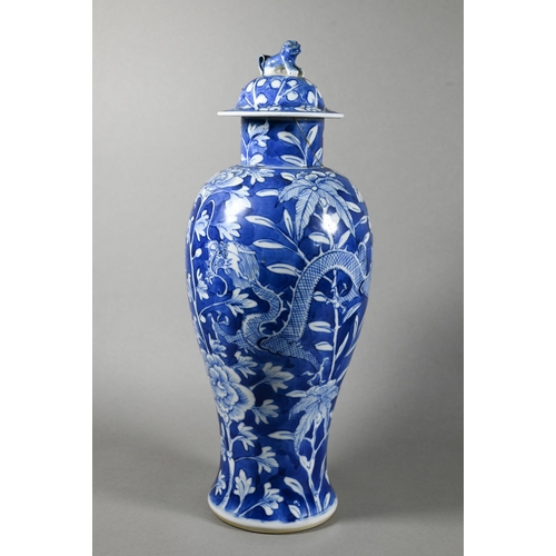 513 - A pair of 19th century Chinese blue and white vases with domed covers surmounted by guardian lion fi... 