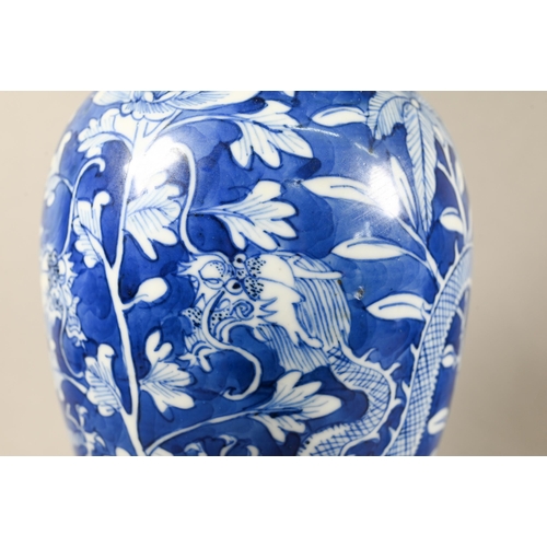 513 - A pair of 19th century Chinese blue and white vases with domed covers surmounted by guardian lion fi... 