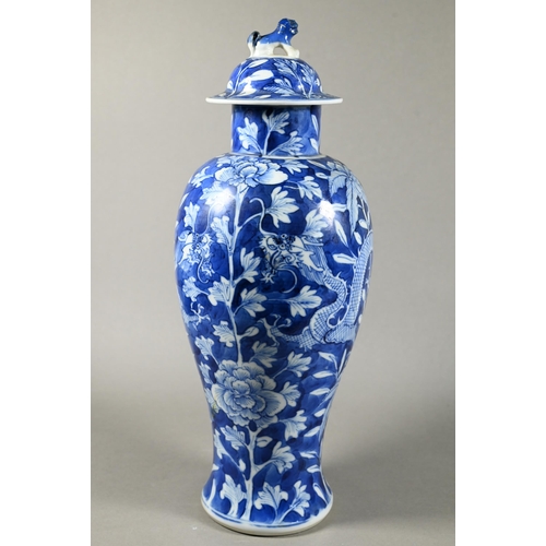 513 - A pair of 19th century Chinese blue and white vases with domed covers surmounted by guardian lion fi... 